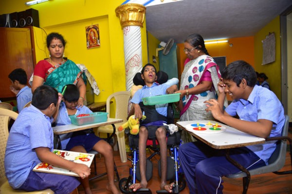 Teachers supporting children with special needs during therapy