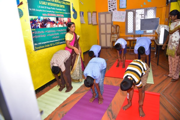Children practising yoga at the early intervention centre