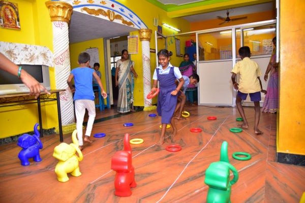 Children playing ring-toss games during physical training