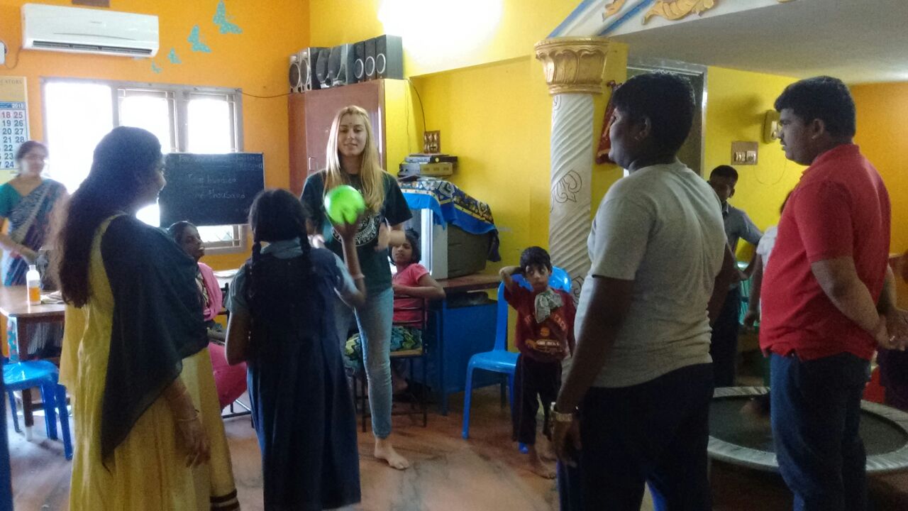 A volunteer engaging children at Hope Chennai during an activity session